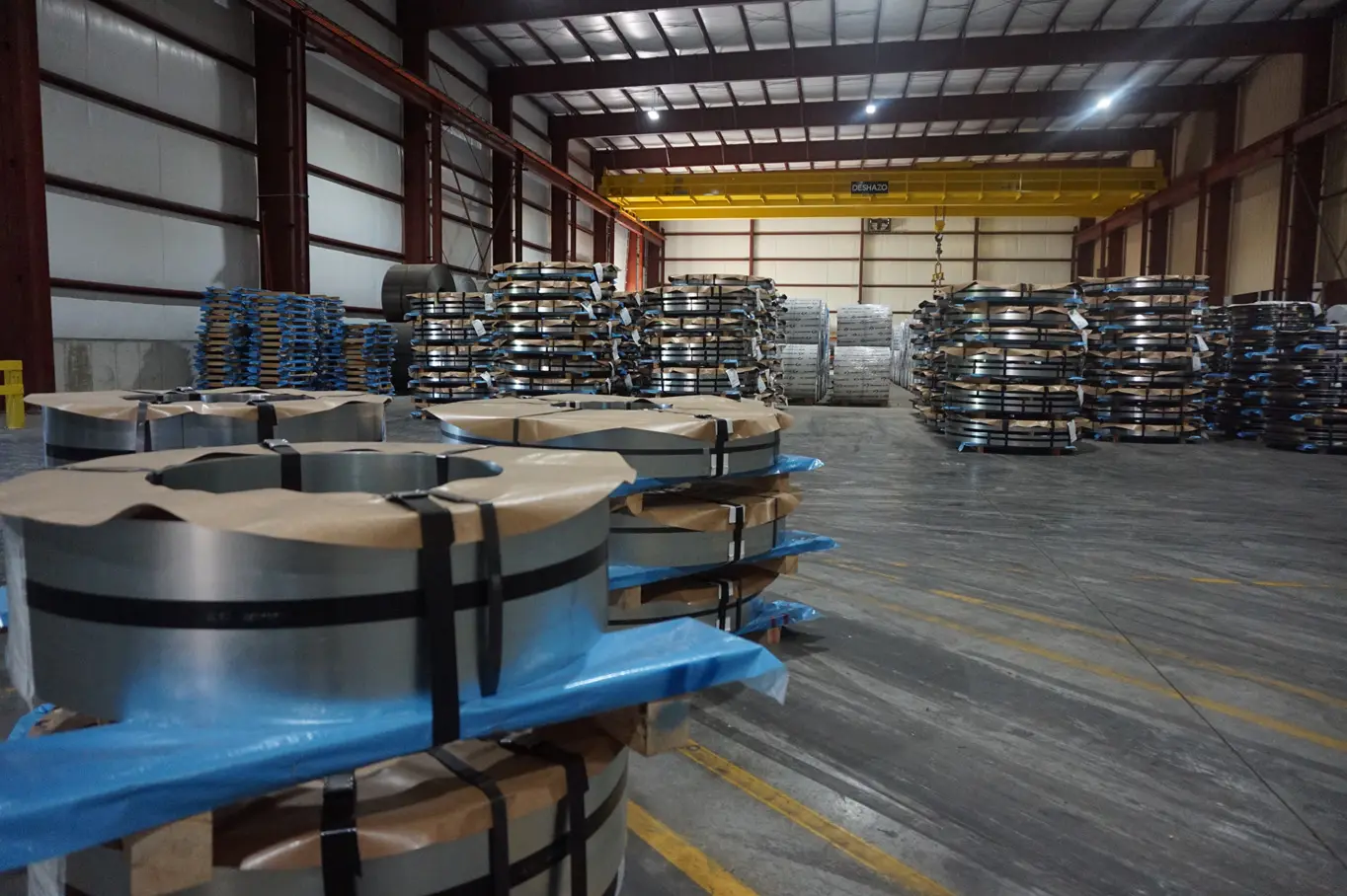 Banded slit steel coils on pallets staged in the Magic Coil Products warehouse