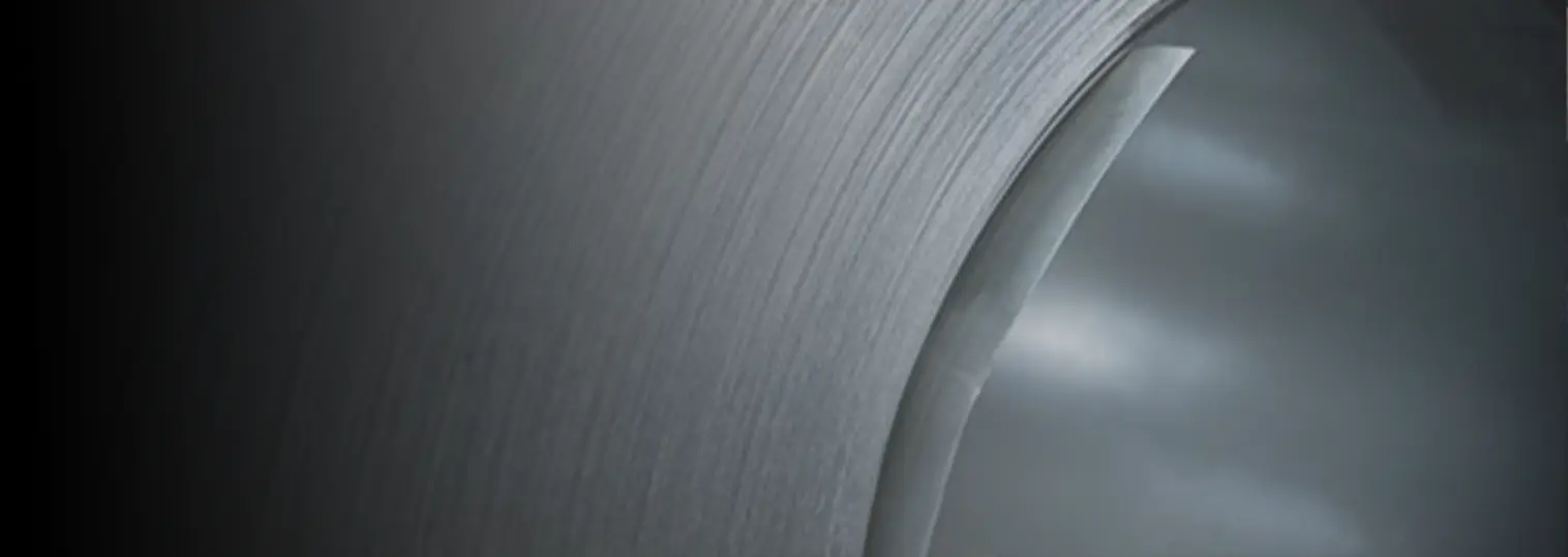 Close-up of the brushed surface and wound edge of a polished stainless steel coil