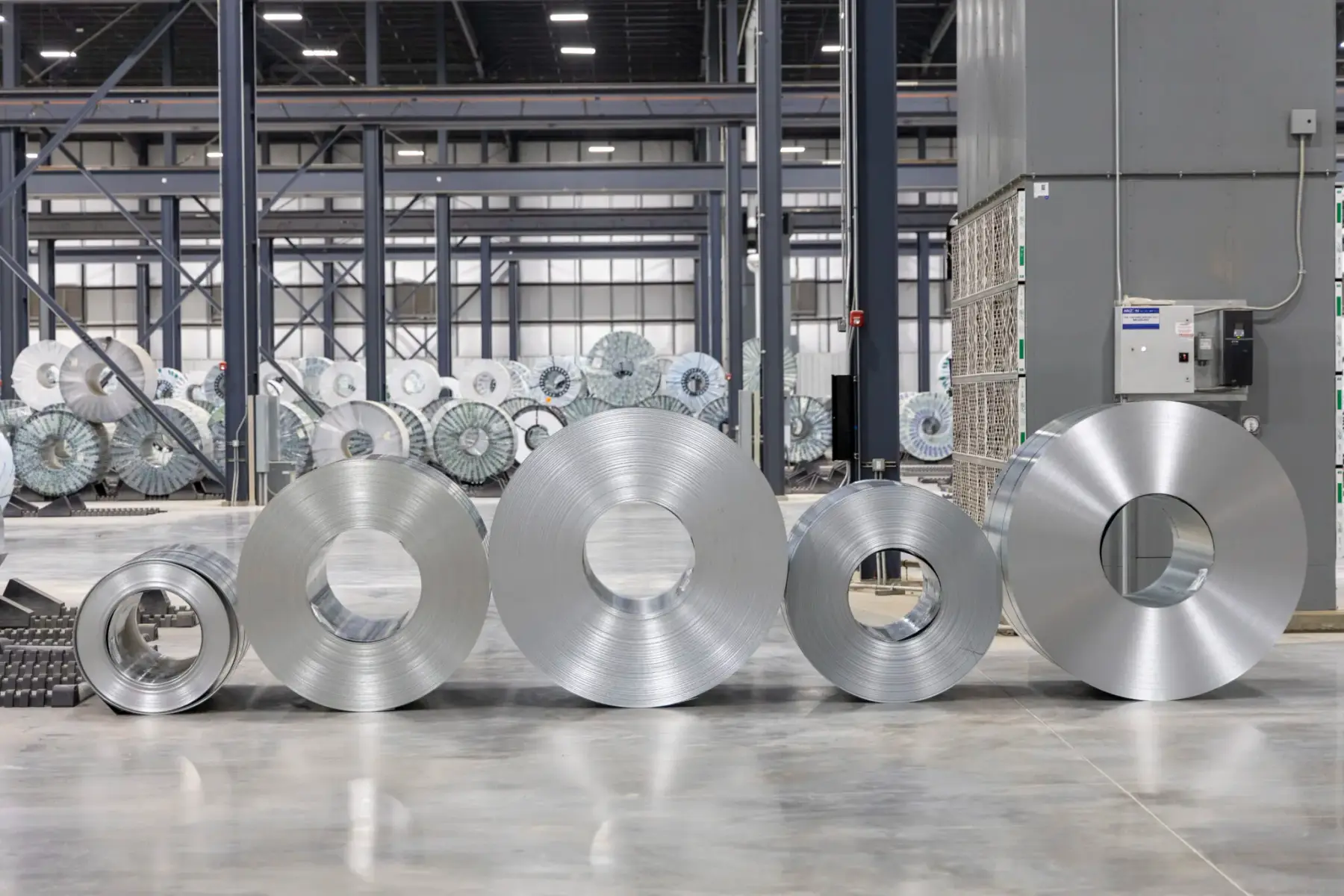 Row of bare galvanized steel coils on the floor of Majestic's Arkansas warehouse