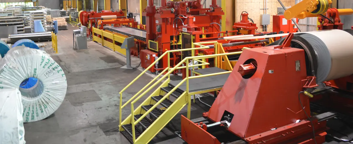 Red cut-to-length line with coil entry and stacker inside Maryland Metals Processing's Baltimore plant
