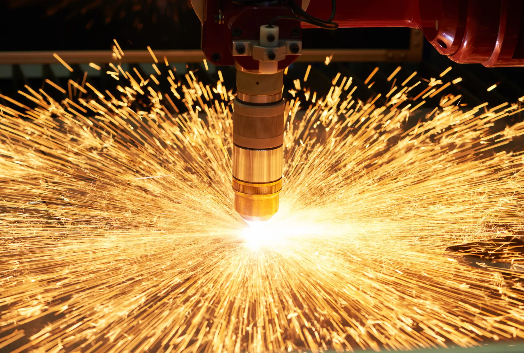 Plasma torch cutting steel plate in a shower of sparks at Maxx Metals