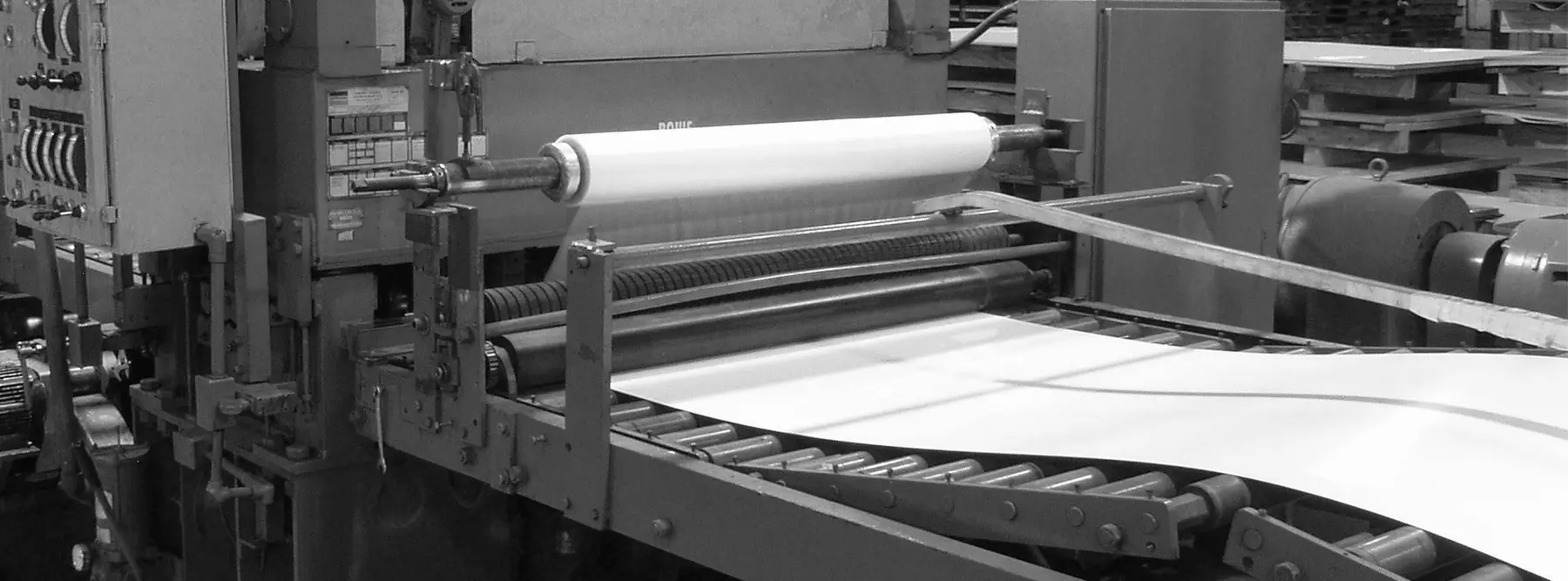 Sheet exiting the McEver cut-to-length line under a PVC film applicator roll