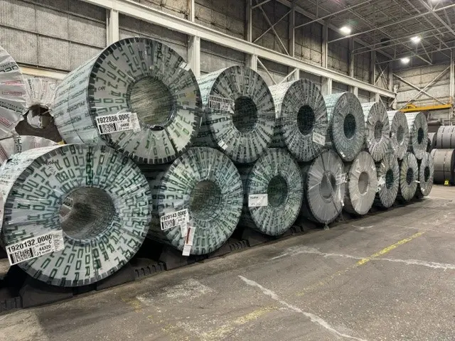 Rows of wrapped master coils in storage inside the MD Metals warehouse