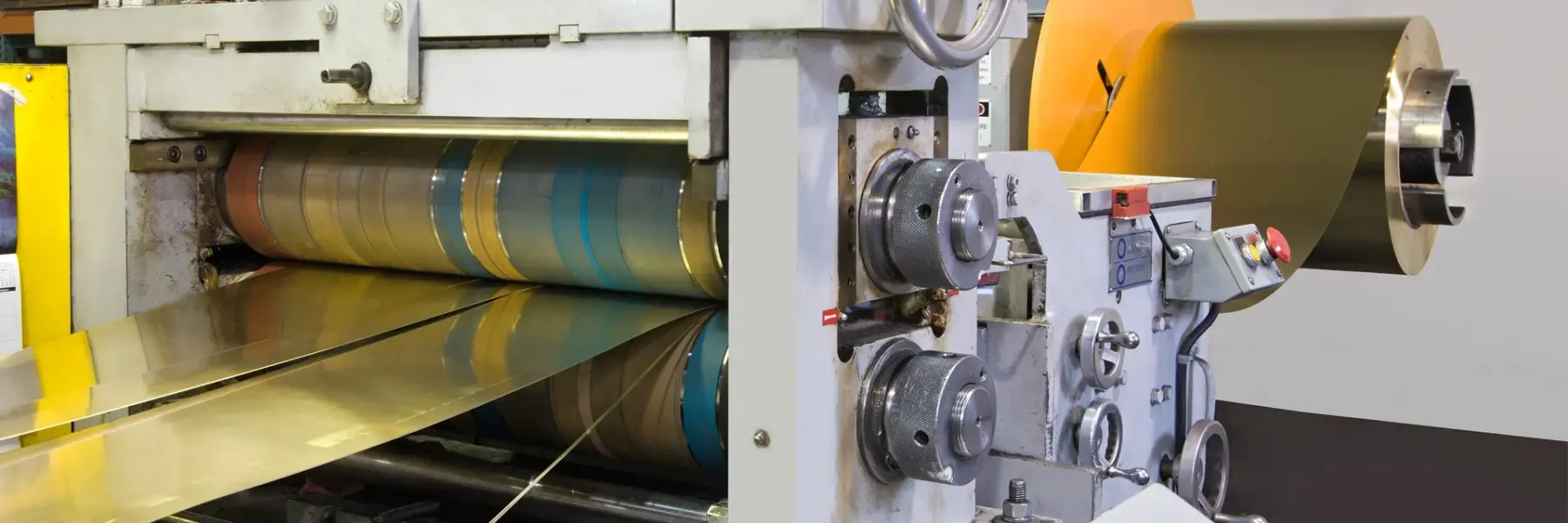 Bright metal strip running through the slitter knives on Mead Metals' precision slitting line