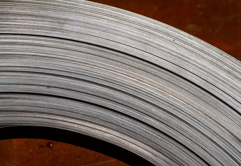 Close-up of a coil of thin metal strip stocked by Metalmen Sales