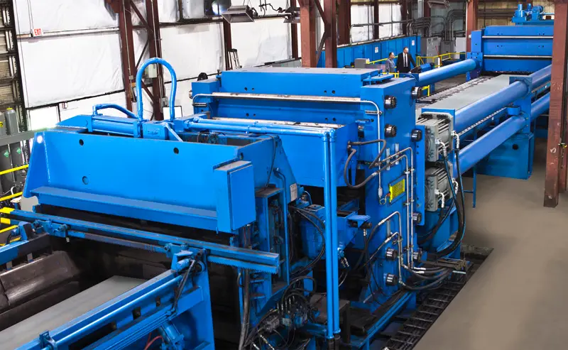 Blue Leveltek stretch leveling line on the plant floor at MidWest Materials in Perry, Ohio