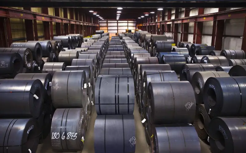 Rows of hot-rolled steel coils stored in a MidWest Materials warehouse bay