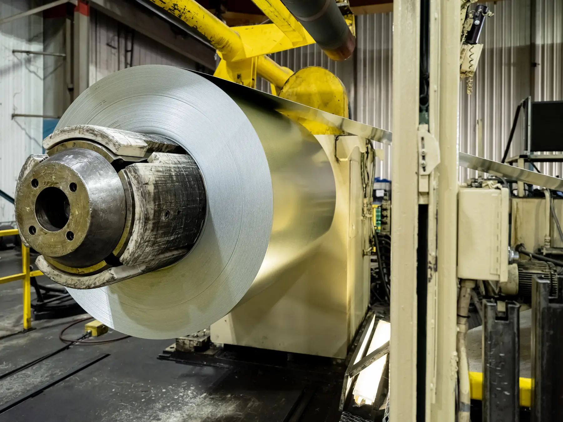 Steel coil mounted on an uncoiler at the entry of a Mill Steel slitting line