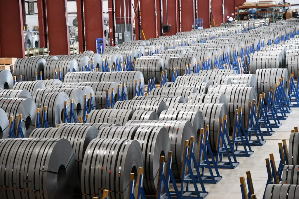 Rows of slit steel coils staged on blue coil stands in a MISA Metal Processing warehouse