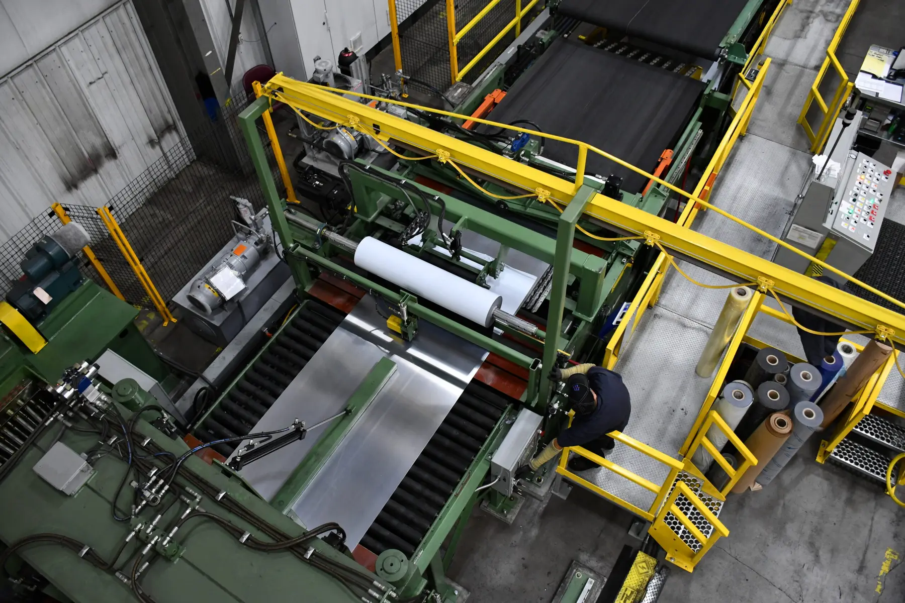 Coil-fed blanking line with yellow safety rails seen from above