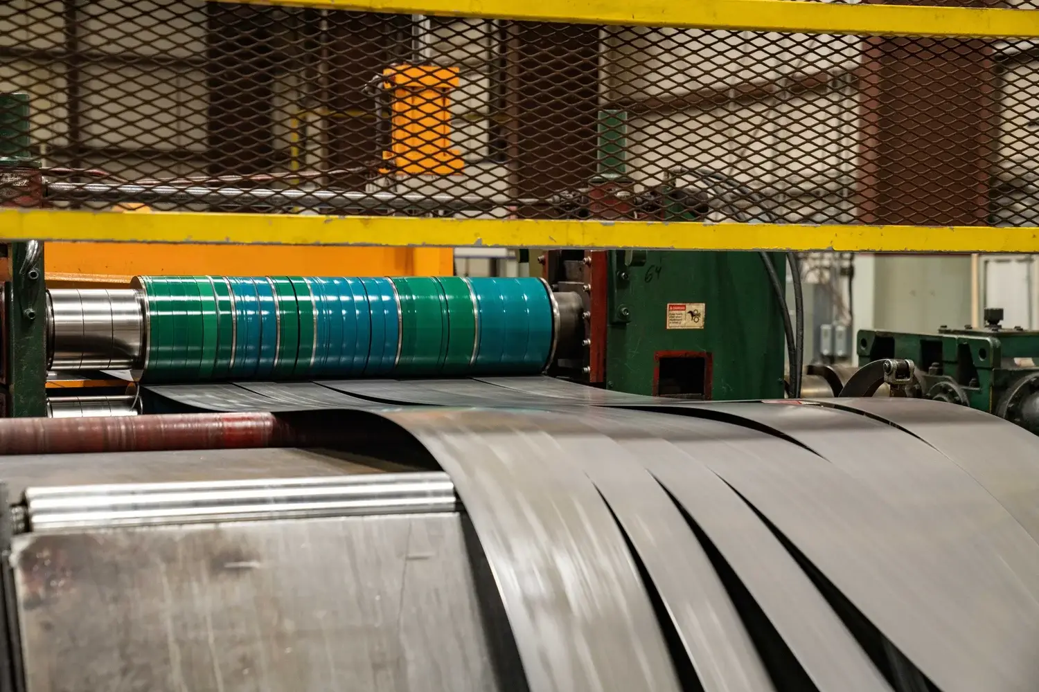 Slit steel strands running through the slitting line at Northern Steel Industries in Burns Harbor