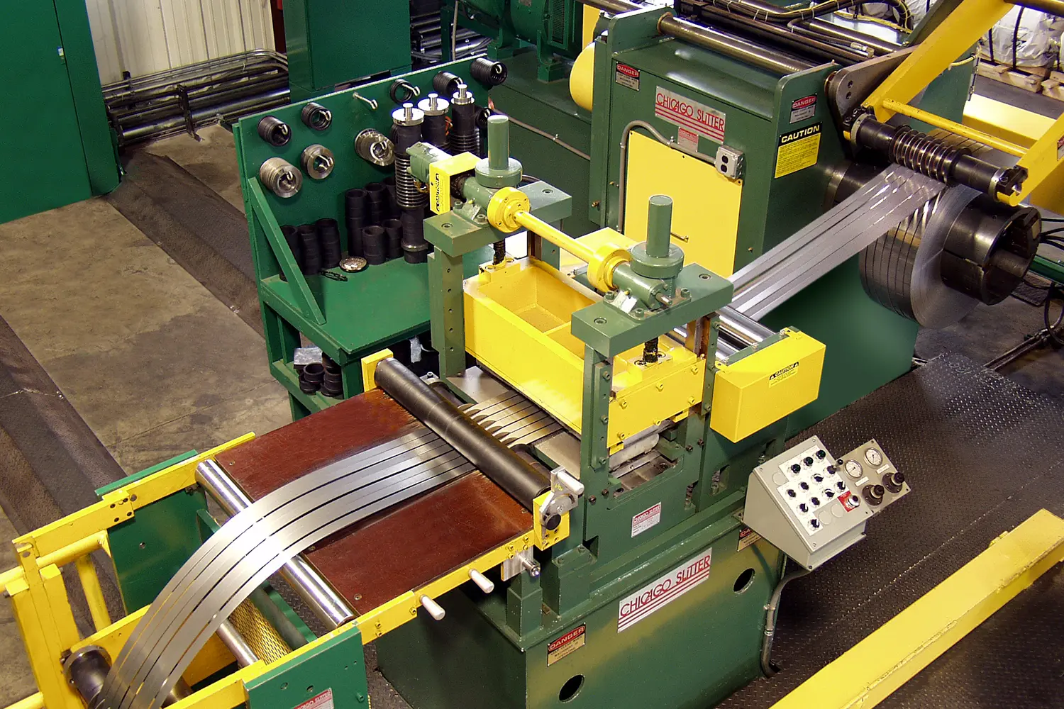 Chicago slitter separating steel strip into narrow mults ahead of the recoiler