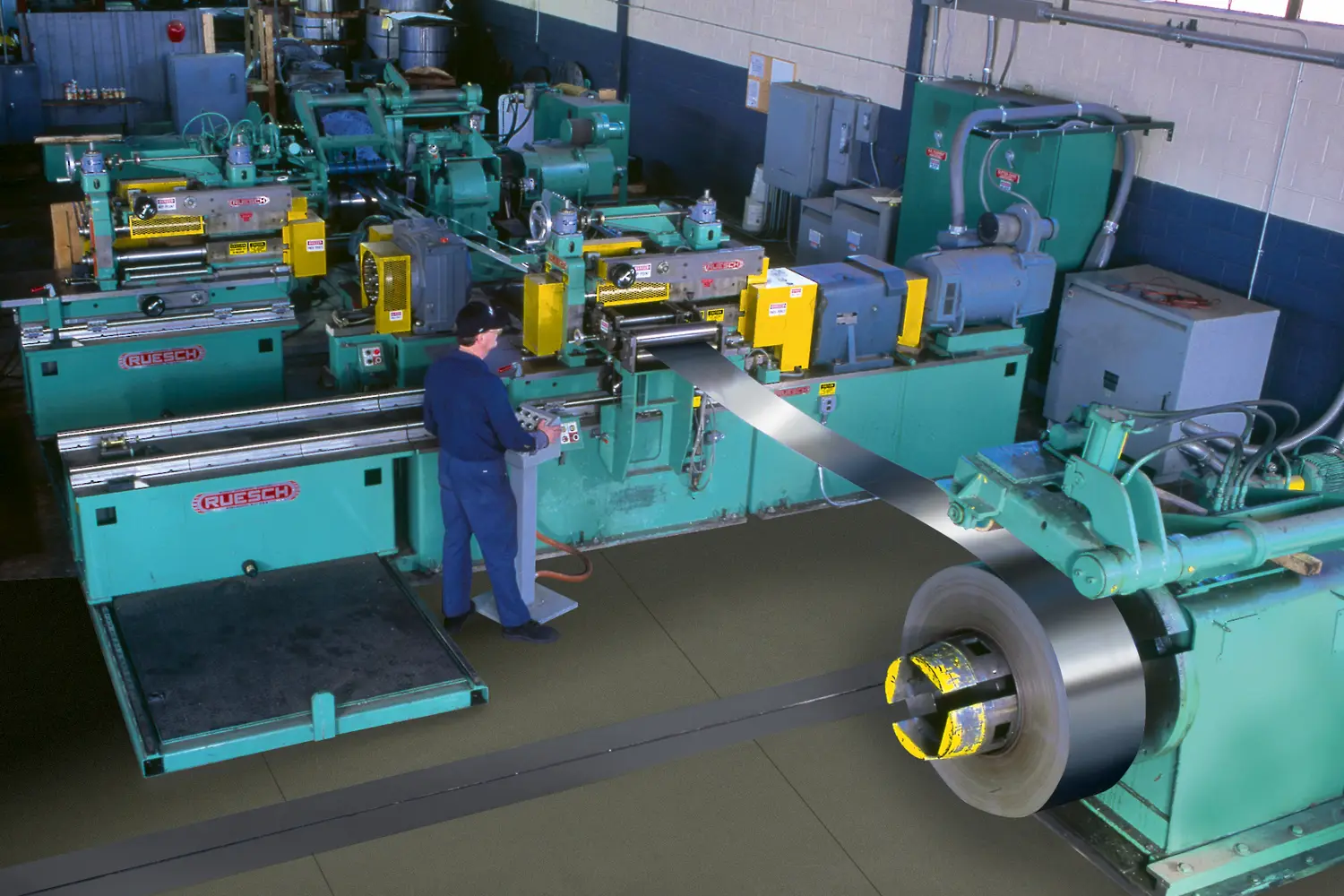 Dual-head Ruesch slitter with operator and freshly slit coil on the recoiler