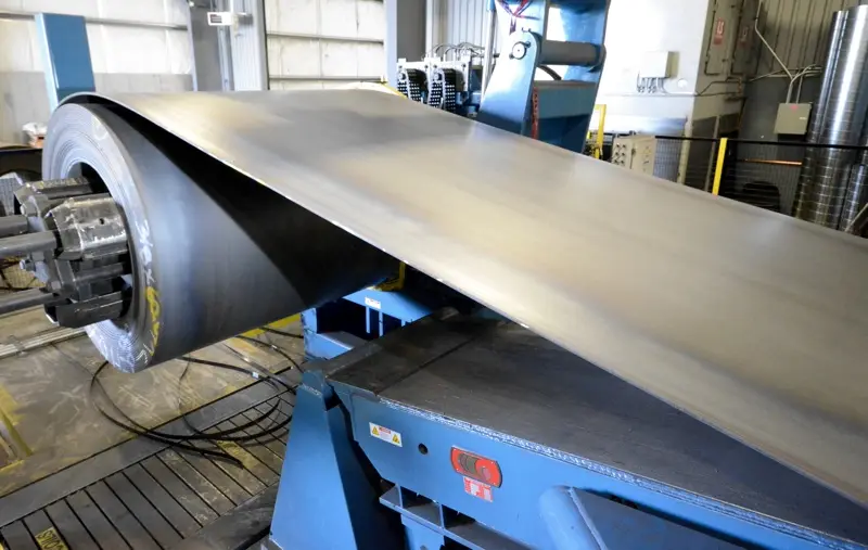 Steel strip feeding off the uncoiler of a 72-inch cut-to-length line at Oregon Metal Services