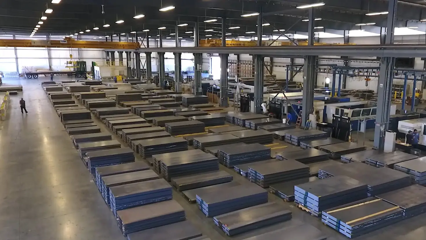 Rows of stacked steel sheet inventory in the Owen steel service center warehouse