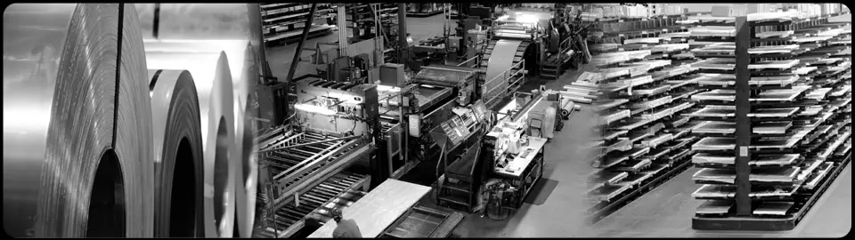 Metal coils beside Pacific Metal Company's multi-blanking line and racks of cut sheet in the Portland plant