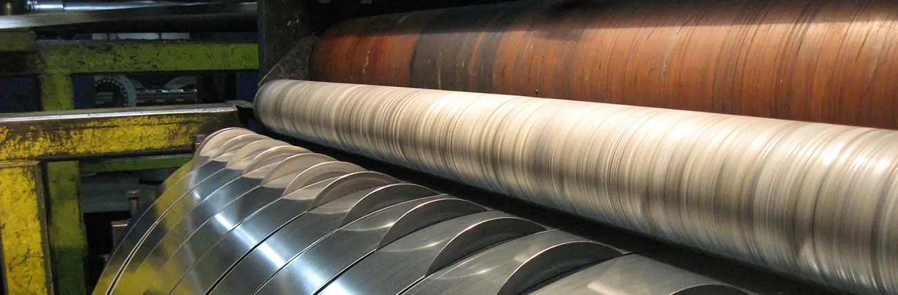 Slit steel strands winding off the slitter knives on a Paragon Steel slitting line