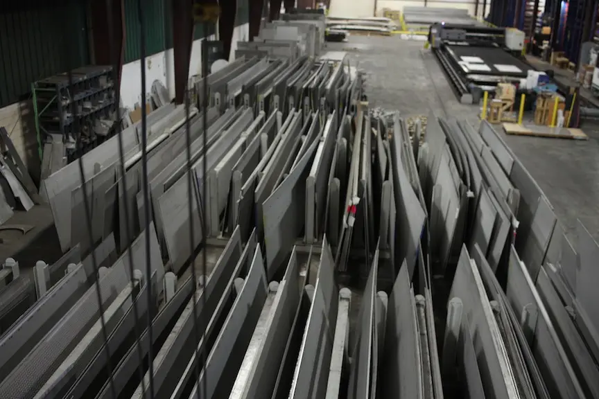 Rows of stainless steel plate stored upright in warehouse racks