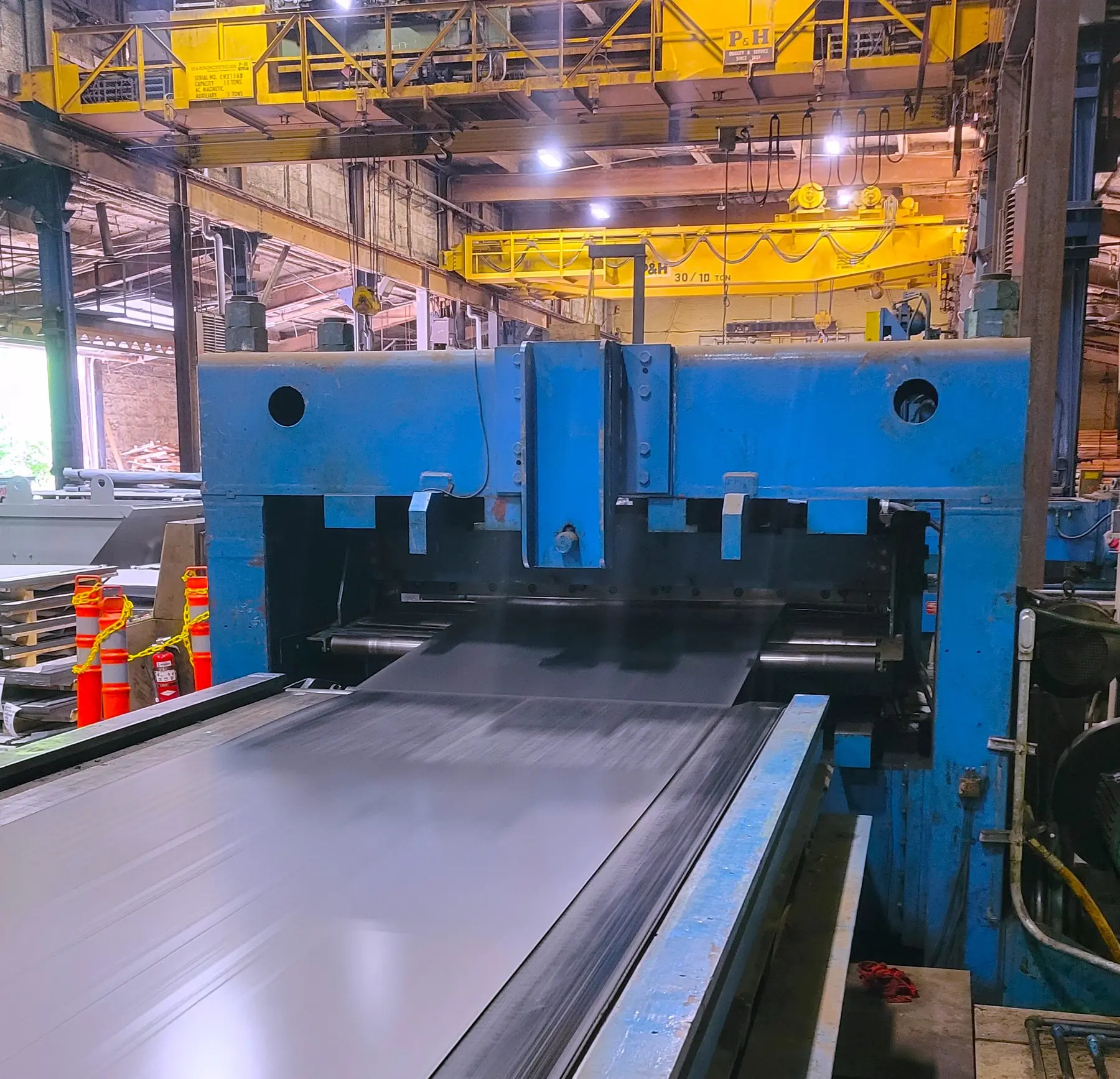 Flat-rolled steel processing line under overhead cranes in the Premium Metals plant in Cleveland