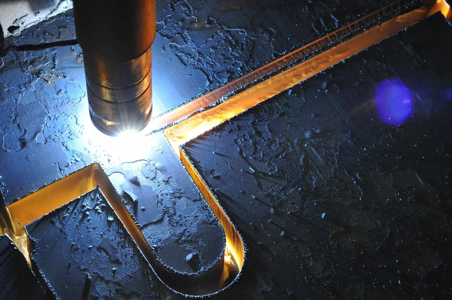 Plasma torch cutting a shape from steel plate