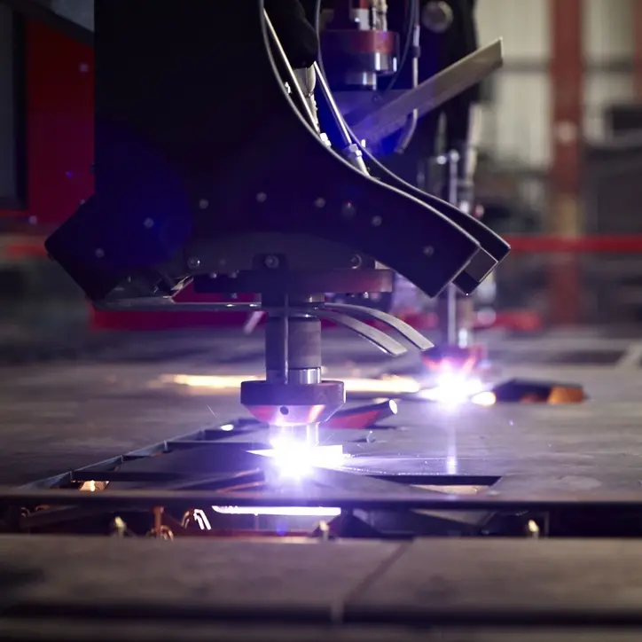 CNC plasma torch cutting steel plate on a burning table