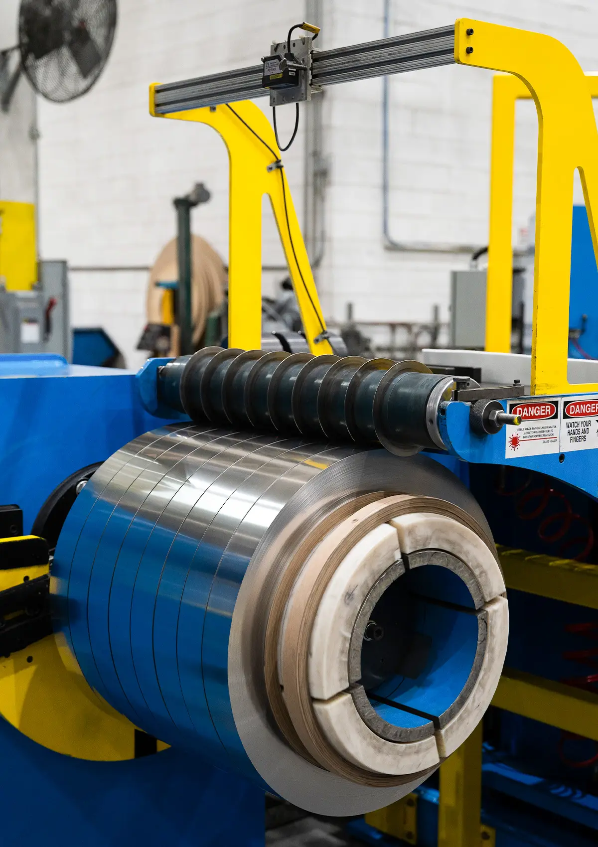 Slit stainless steel strip coil on a recoiler at Rolled Metal Products in Bensalem