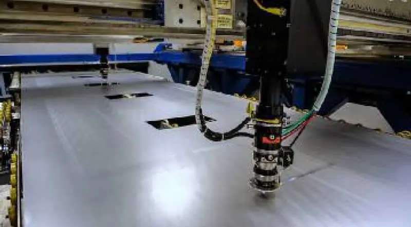 Laser cutting head blanking parts directly from coil-fed sheet on RSDC's laser blanking line