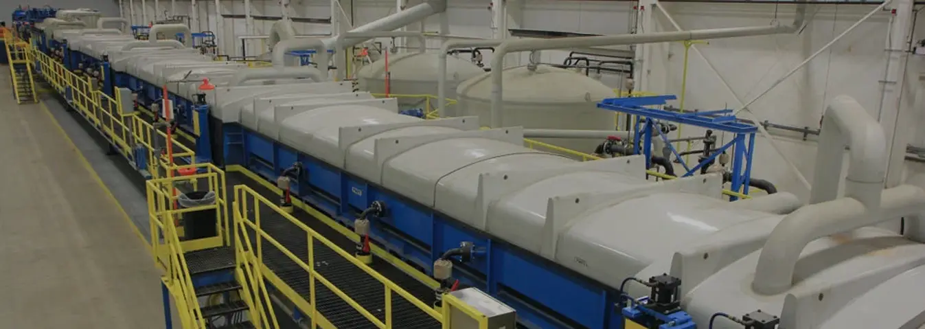 Enclosed steel pickling line with walkways running the length of the plant