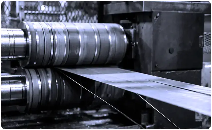 Slitter knives cutting steel strip on a Scott Steel slitting line