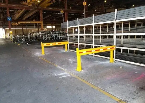 Warehouse bay at Smith Pipe & Steel with racked structural steel and overhead cranes