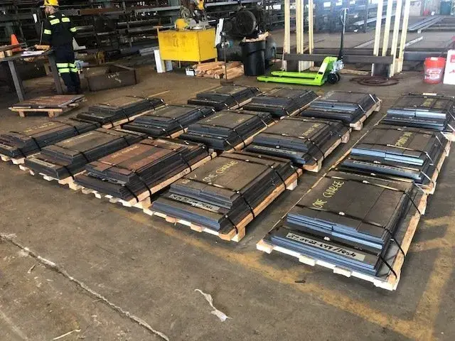 Pallets of cut steel plate parts banded and ready to ship on the Smith Pipe & Steel warehouse floor