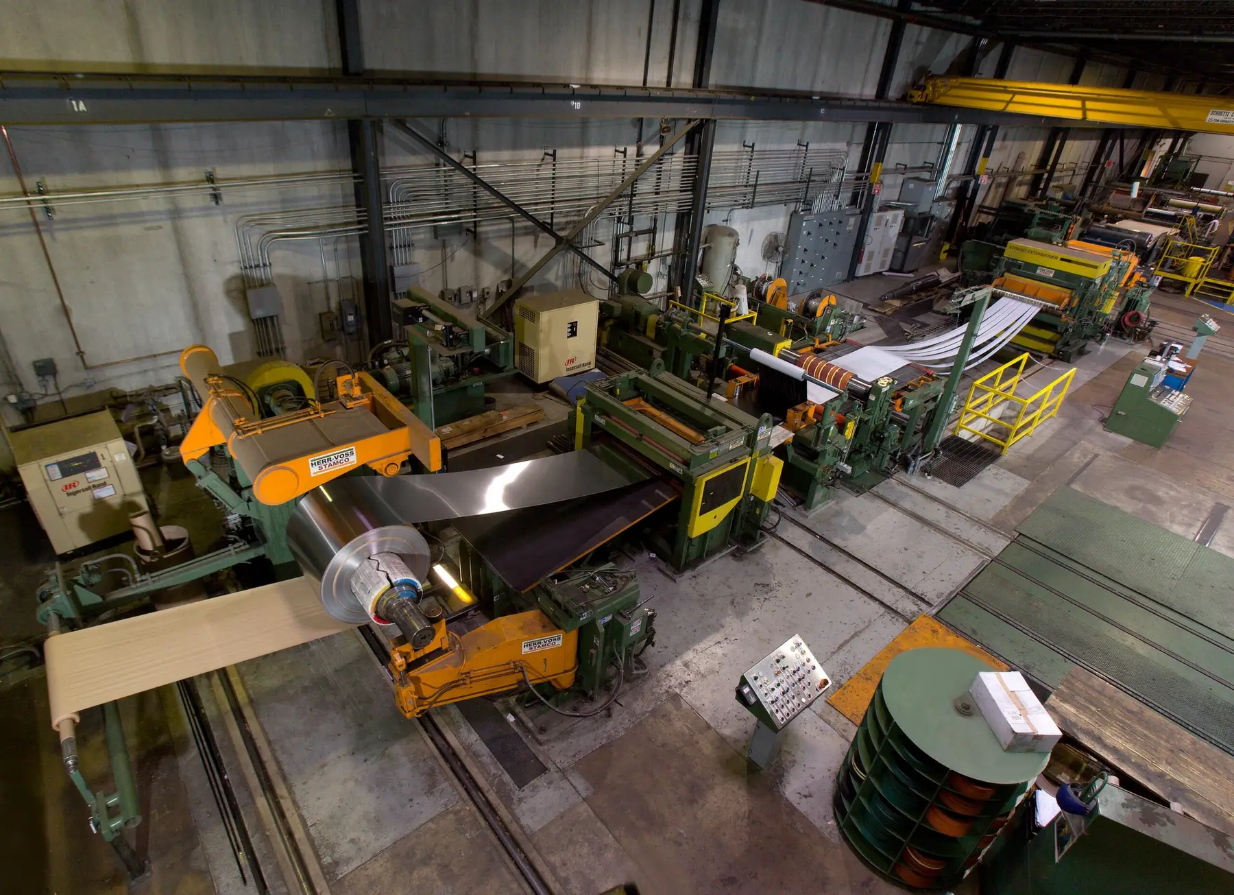 Stainless coil running through a slitting line in Specialty Rolled Metals' Carol Stream plant