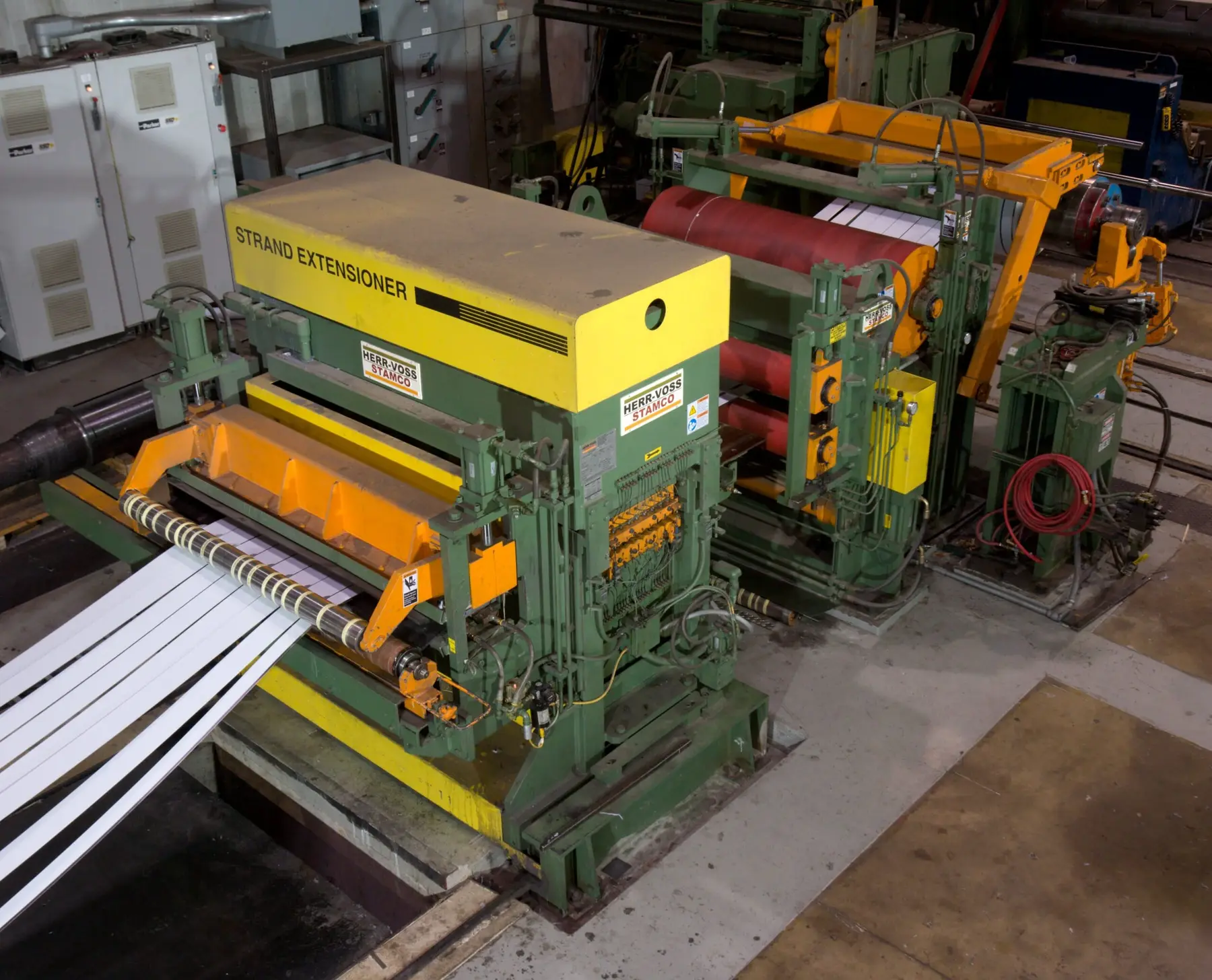Slit stainless strands passing through a strand extensioner on an SRM slitting line
