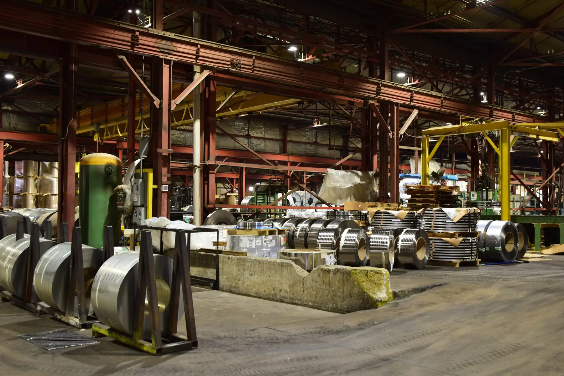 Production floor of the Specialty Strip plant in Masury, Ohio, with slit coils staged beside the processing lines
