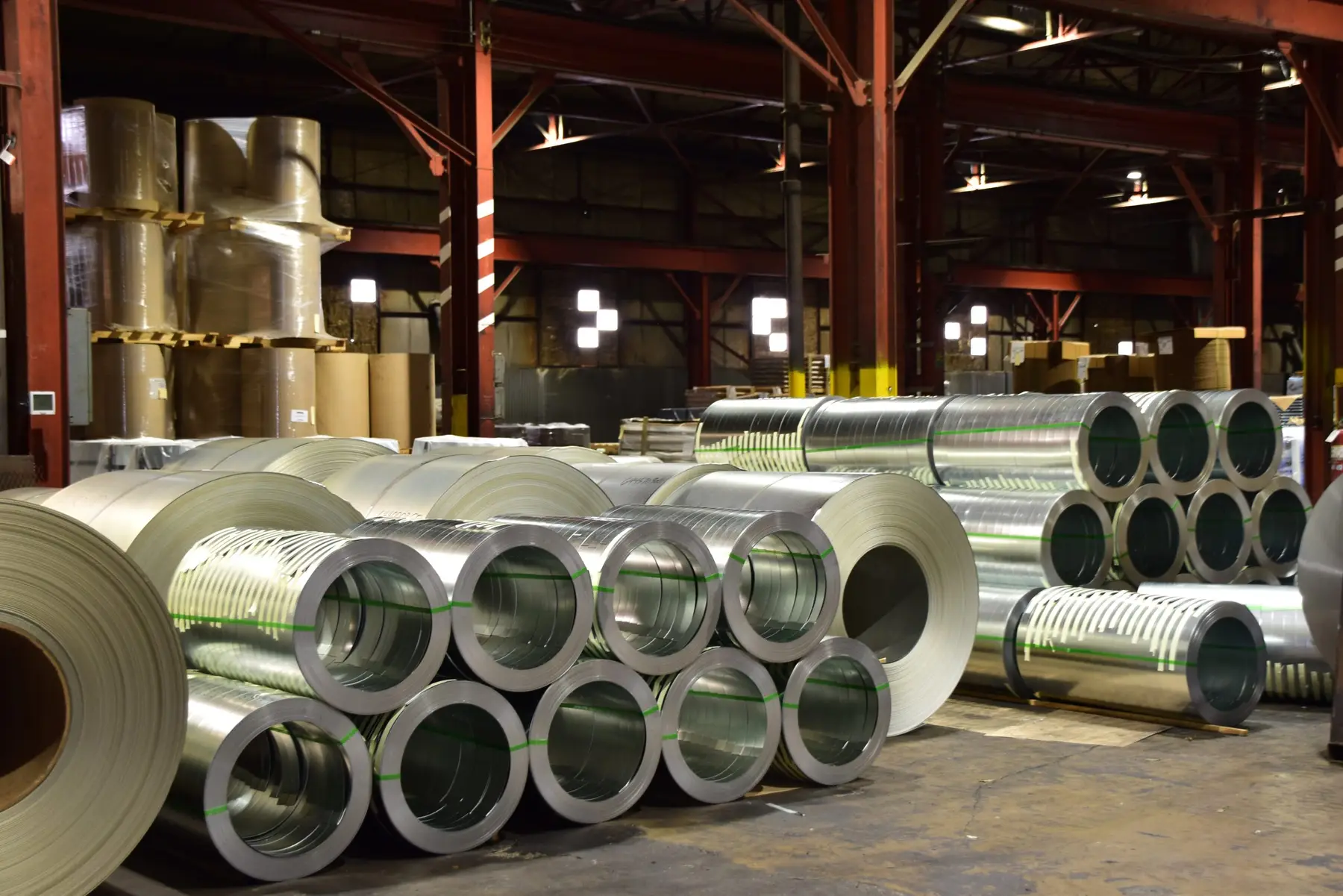 Rows of slit steel coils stored on the floor of the Specialty Strip plant