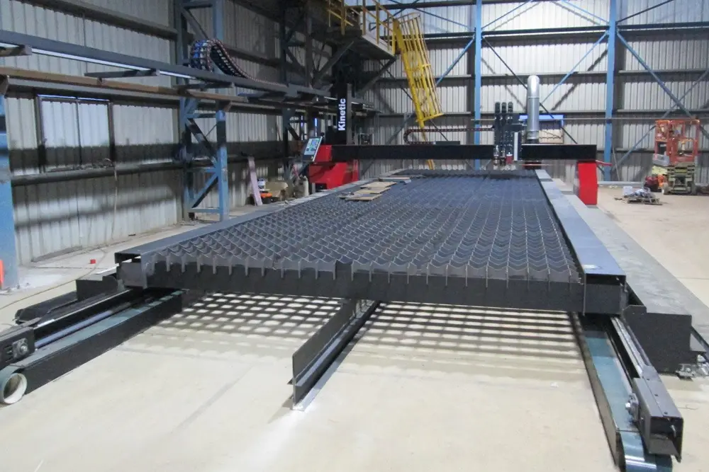 Long Kinetic K2500 plasma table installed inside a steel processing building