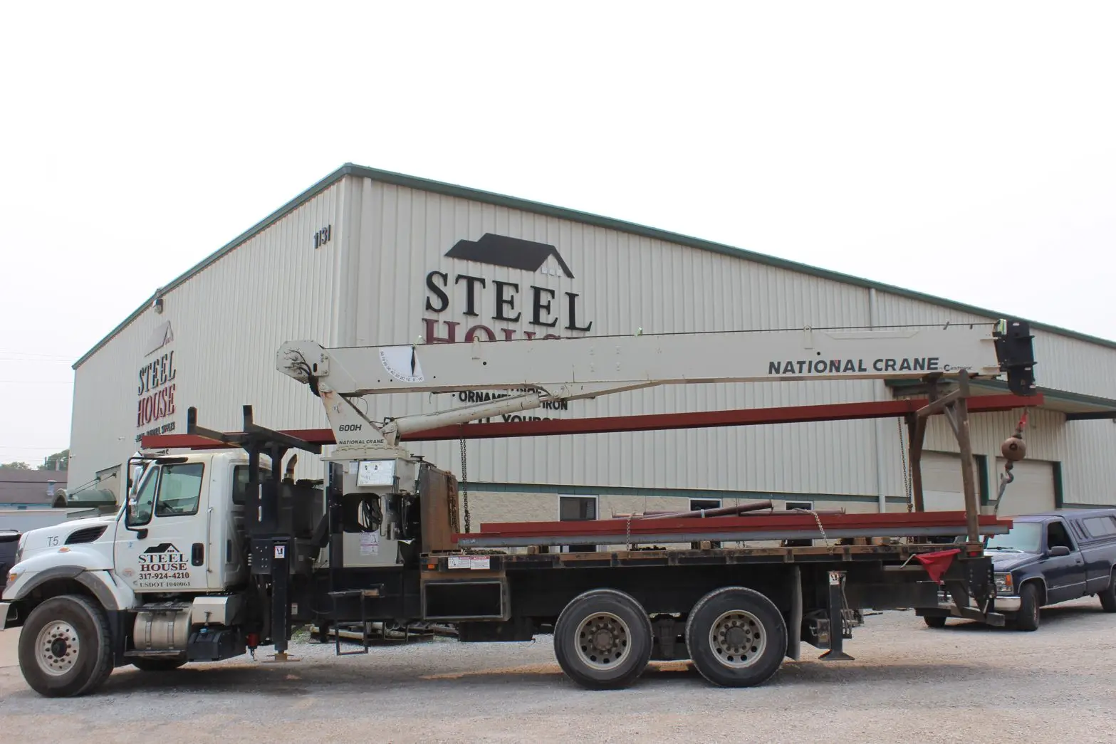 Steel House crane truck loaded with steel beams outside the Indianapolis warehouse
