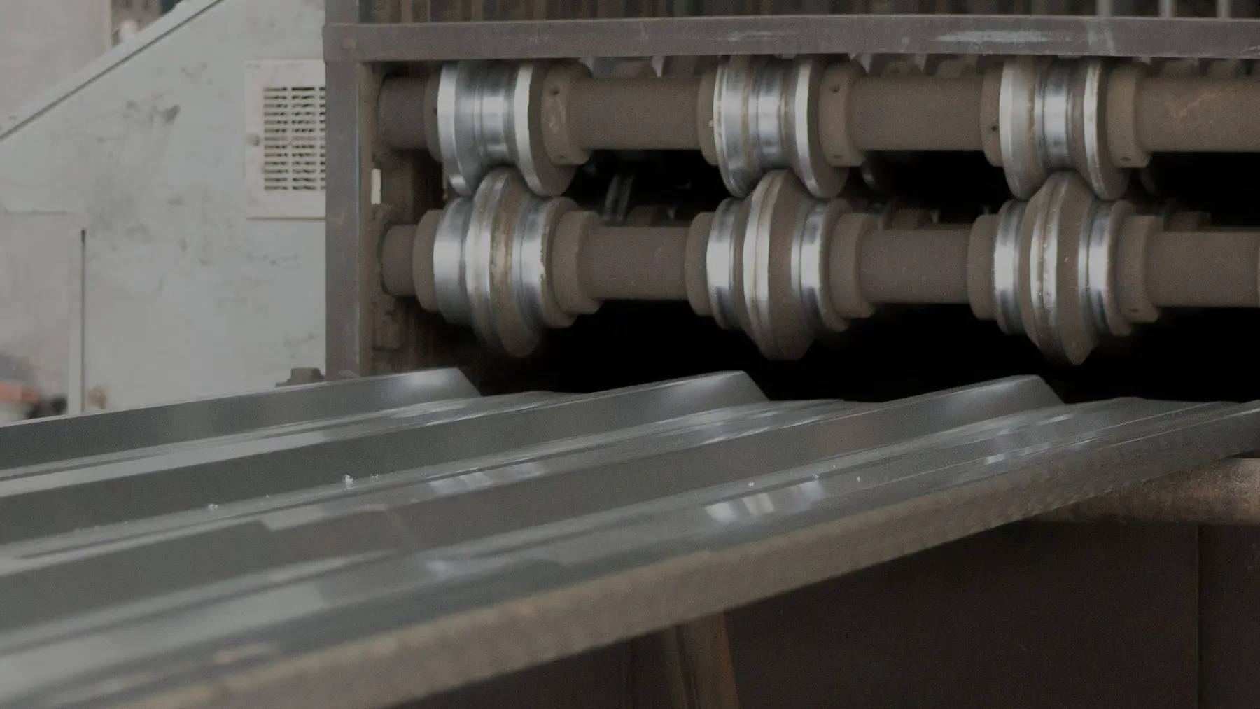 Roll forming stands shaping galvanized R-Panel at Steel Surplus in Houston