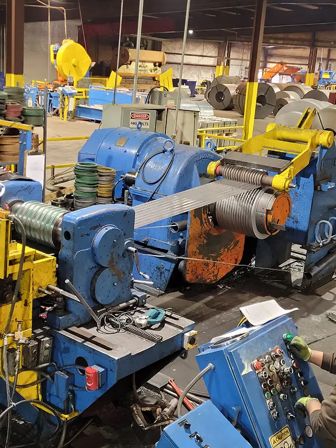 Slitting line recoiling narrow steel strip on the Sunbelt Metal Processing plant floor