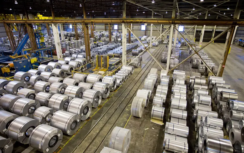 Rows of steel coils in indoor storage bays at a Taylor Steel plant