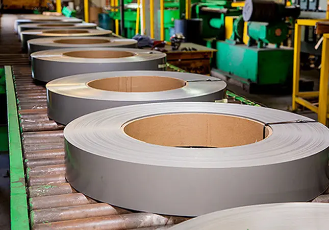 Slit electrical steel coils lined up on a roller conveyor