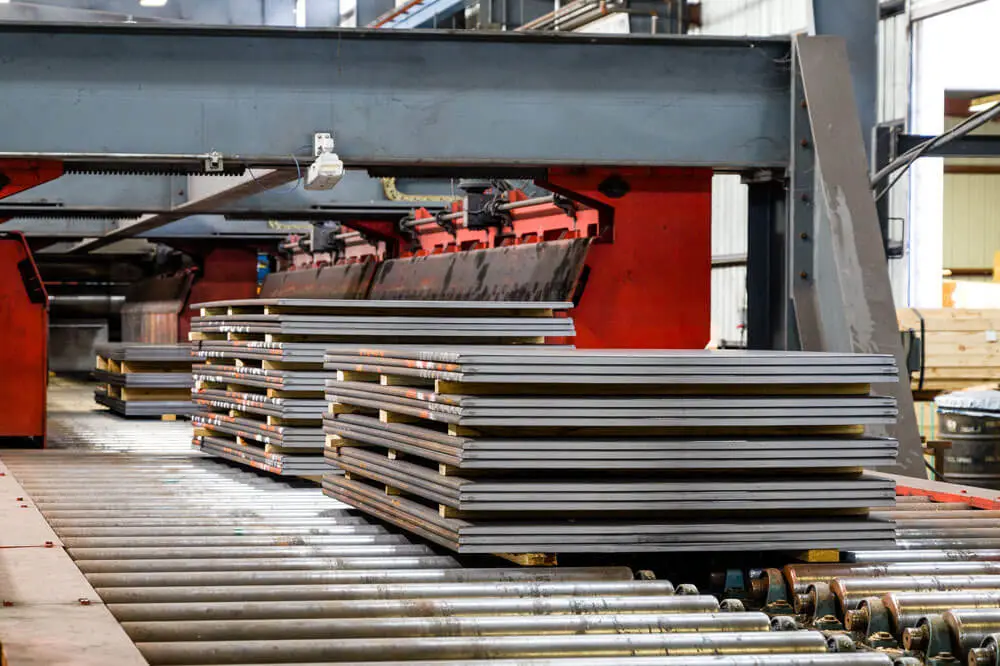 Stacks of cut-to-length steel sheet on a roller conveyor at Beshert