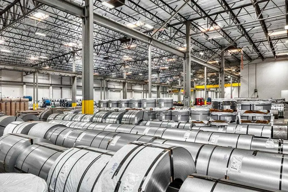 Large warehouse filled with rows of flat-rolled steel coils