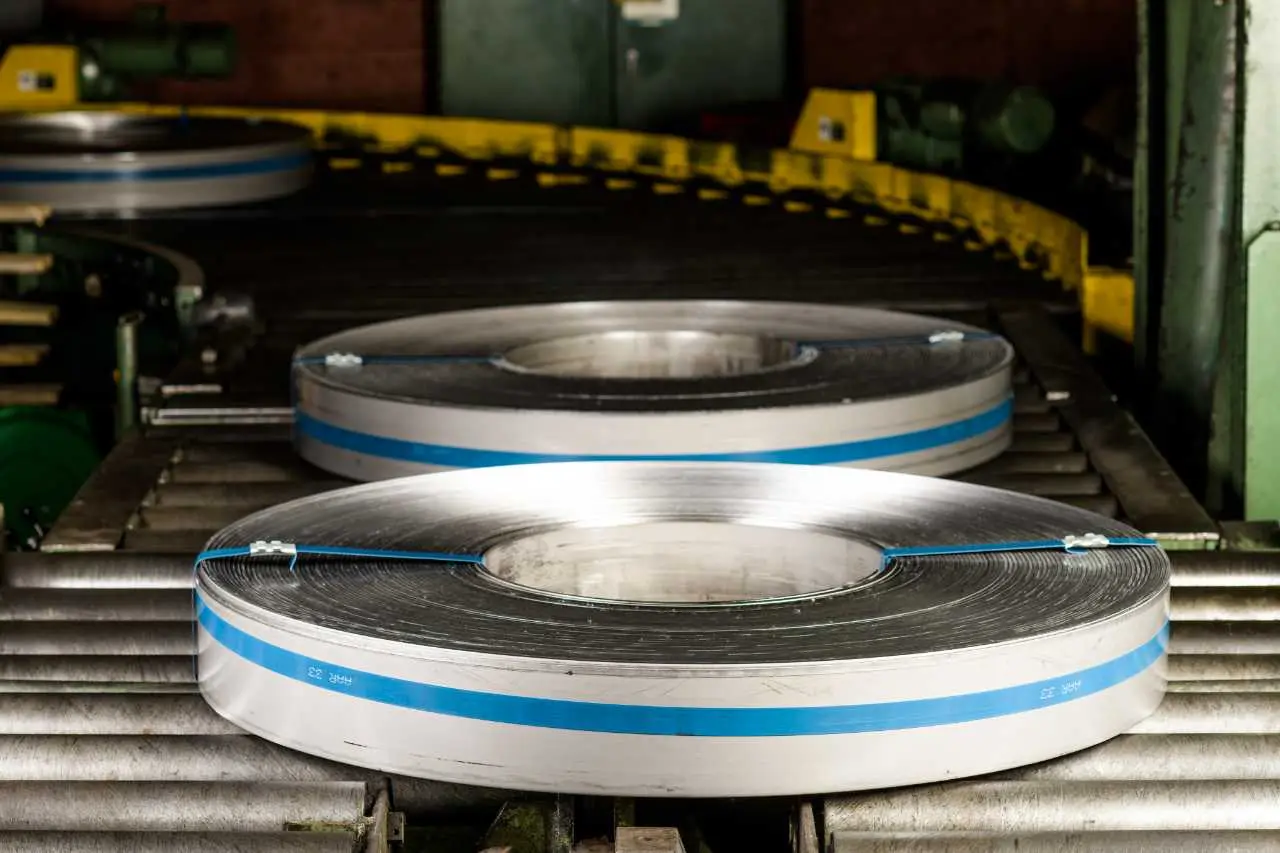 Banded slit steel coils on a roller conveyor at the exit of the slitting line