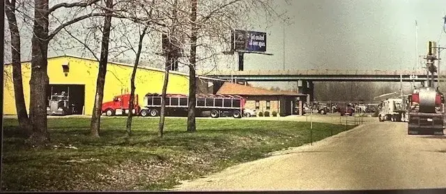Exterior of the Vitco Steel plant with trucks at the loading area