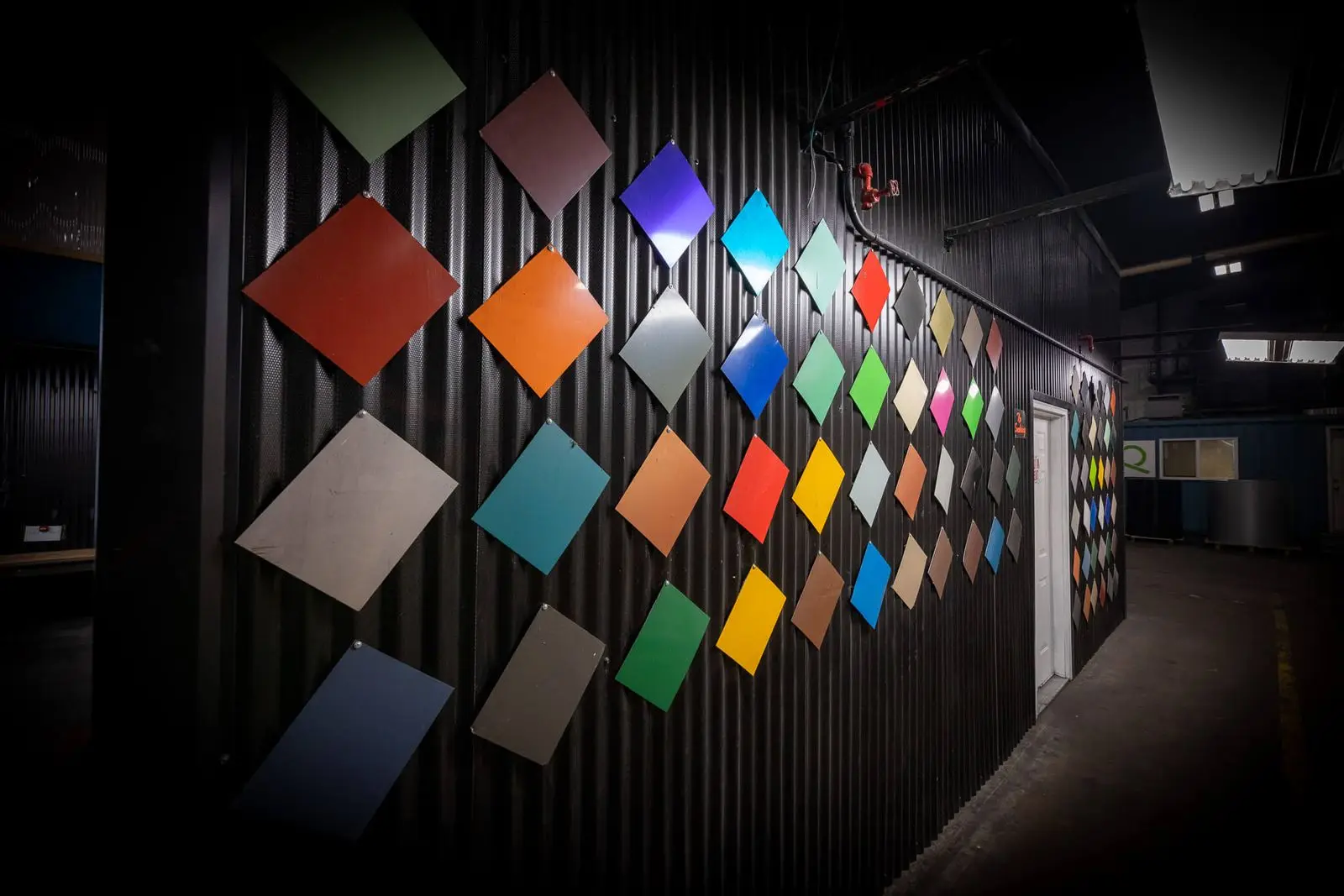 Wall of painted metal color panels displayed inside a VORTEQ facility