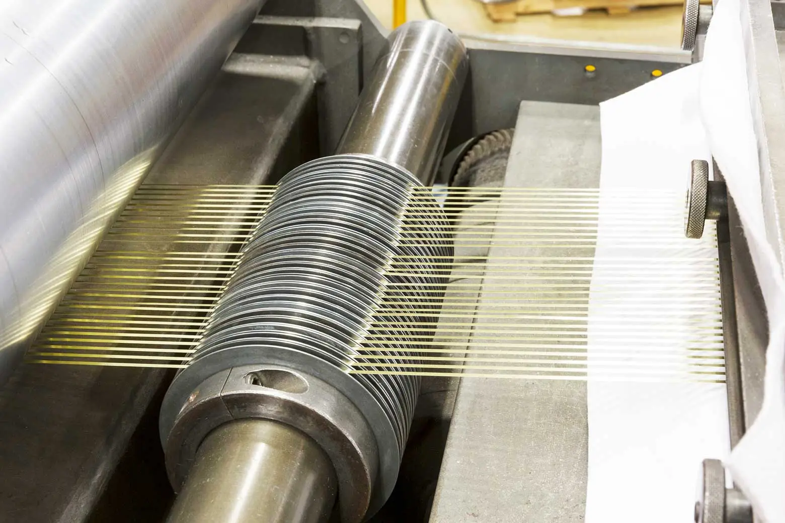 Slitter knives cutting copper alloy strip into narrow widths at Wieland Metal Services